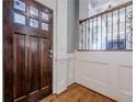 Foyer with a dark wood door, hardwood floors, and a staircase leading to the upper level at 2647 Brickell Sq, Atlanta, GA 30341