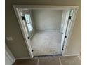 A spacious room with natural light streaming through the window and door with dark hardware at 41 Okeechobee Way, Braselton, GA 30548
