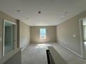 A bright bonus room with a large window letting in natural light and two entry doorways at 41 Okeechobee Way, Braselton, GA 30548