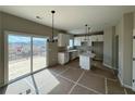 Bright kitchen with white cabinets, an island, stainless steel sink and sliding glass doors to the deck at 41 Okeechobee Way, Braselton, GA 30548