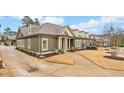 Craftsman-style home with green siding, white trim, and a well-manicured lawn at , Acworth, GA 30101