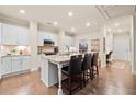 Bright kitchen features white cabinets, granite countertops, and a central island with bar seating at , Acworth, GA 30101