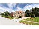 Elegant two-story brick home with lush landscaping and a spacious driveway at 1236 Saxony Se Dr, Conyers, GA 30013