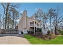 Back view of a two-story home, with a two car garage and driveway at 3080 Autumn Woods Ct, Douglasville, GA 30135