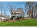 Charming two-story home with a welcoming front porch and a lush green lawn at 3080 Autumn Woods Ct, Douglasville, GA 30135