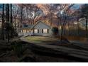 Exterior view of the home at sunset with mature trees and manicured landscaping at 241 Lancaster Cir, Marietta, GA 30066