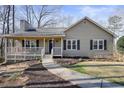 Charming home with a cozy covered porch, perfect for enjoying the outdoors at 241 Lancaster Cir, Marietta, GA 30066