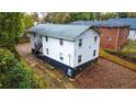 A rear view of the two-story home featuring a staircase and brick facade at 1152 Greenwich Sw St, Atlanta, GA 30310