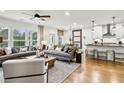 Open-concept living space featuring hardwood floors and a comfortable seating arrangement at 5410 Julep Ct, Cumming, GA 30028