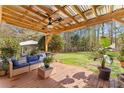 Inviting covered patio with outdoor seating, fan, string lights, and view of the backyard at 8078 Longleaf Dr, Villa Rica, GA 30180