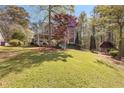 Landscaped front yard with mature trees and inviting curb appeal, showcasing the home's facade at 8078 Longleaf Dr, Villa Rica, GA 30180