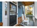 Inviting front porch featuring rocking chairs, brick accents, and a stylish front door at 1514 Gilstrap Nw Ln, Atlanta, GA 30318