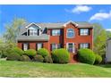 Beautiful two-story brick home with a manicured lawn and blue sky, creating an inviting curb appeal at 1710 Brandon Lee Sw Way, Marietta, GA 30008