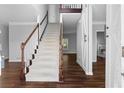 Inviting foyer with hardwood floors, a staircase, and an open view into other rooms at 1710 Brandon Lee Sw Way, Marietta, GA 30008