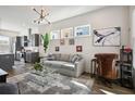 Open-concept living room with modern lighting, stylish furnishings, and seamless kitchen access at 203 Color Cir, Atlanta, GA 30317