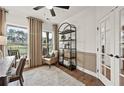Bright home office with a desk, chair, bookshelf, and a large window overlooking the outdoors at 5310 Julep Ct, Cumming, GA 30028