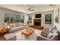 Bright, staged living room features a brick fireplace and large windows offering great natural light at 9704 Pintail Trl, Jonesboro, GA 30238