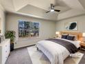 Relaxing main bedroom boasts a tray ceiling, a ceiling fan, and a large bright window at 9704 Pintail Trl, Jonesboro, GA 30238