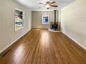Spacious living room featuring hardwood floors and a modern fireplace at 3668 Bunker Hill Sw Dr, Atlanta, GA 30331
