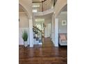 Elegant foyer with hardwood floors, staircase, and decorative columns at 1001 Brading Pl, Lawrenceville, GA 30043