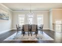 Elegant dining room with stylish chandelier, hardwood floors, and natural light at 10035 River Rock Dr, Roswell, GA 30076