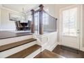 Inviting entryway with wood floors and staircase leading to the dining area at 10035 River Rock Dr, Roswell, GA 30076