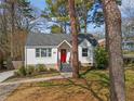 Beautiful white painted home with a red door, complemented by mature trees and a well-maintained front yard at 1784 Terry Mill Se Rd, Atlanta, GA 30316