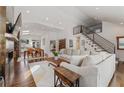 Bright, open living room with high ceilings, hardwood floors, modern fireplace, and metal staircase at 1784 Terry Mill Se Rd, Atlanta, GA 30316
