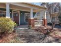Inviting front porch with classic white columns, brick accents, and a charming seating area, perfect for relaxing at 424 Morgan Se Pl, Atlanta, GA 30317