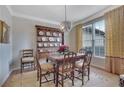 Traditional dining room featuring a wooden table set, chandelier, and bright natural light at 480 Firelite Ln, Suwanee, GA 30024