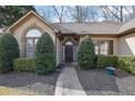 Inviting home exterior features a manicured lawn, mature bushes, and a classic front door at 480 Firelite Ln, Suwanee, GA 30024
