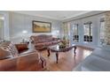 Cozy living room with hardwood floors, leather furniture, and lots of natural light at 480 Firelite Ln, Suwanee, GA 30024