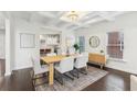 Well lit dining room showcases modern chandelier, rug, and view to kitchen at 5960 Magnolia Rdg, Stone Mountain, GA 30087