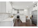 Modern kitchen with stainless steel appliances, island, and white cabinets at 5960 Magnolia Rdg, Stone Mountain, GA 30087