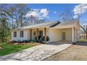 Charming single-story home with white brick, a covered carport, and a well-maintained lawn at 5450 Frazer Rd, Buford, GA 30518