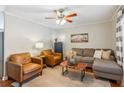 Cozy living room with stylish furnishings, a ceiling fan, and a decorative coffee table at 5450 Frazer Rd, Buford, GA 30518