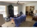 Bright living room with large windows and vintage furniture at 217 Shields Rd, Stockbridge, GA 30281