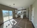Open-concept kitchen with white cabinets, stainless steel appliances, and a breakfast bar island at 61 Okeechobee Way, Braselton, GA 30548