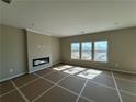 Spacious living room with a modern fireplace and large windows offering plenty of natural light at 61 Okeechobee Way, Braselton, GA 30548