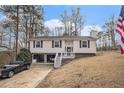Home featuring a two-car garage and a welcoming front porch at 6355 Queens Rd, Douglasville, GA 30135
