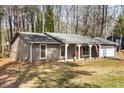 Inviting single-story home boasting a covered entrance, tidy lawn, and a driveway leading to an attached garage at 4575 Jamerson Forest Pkwy, Marietta, GA 30066