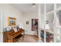 Cozy room with neutral walls featuring a piano, artwork, and comfortable seating area at 755 Creek Wind Ct, Johns Creek, GA 30097