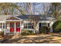 Charming single-story home with a well-maintained front yard and inviting red front doors at 1526 Stone Gate Se Ln, Atlanta, GA 30317