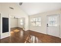 Sunlit living room with gleaming hardwood floors, modern lighting, and an open doorway at 1526 Stone Gate Se Ln, Atlanta, GA 30317