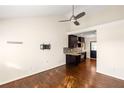 Hardwood living room showcasing ceiling fan, light walls, and an open floor plan to the kitchen at 1526 Stone Gate Se Ln, Atlanta, GA 30317