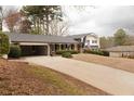 Spacious home featuring an attached carport and a long driveway at 1728 Stonecliff Ct, Decatur, GA 30033