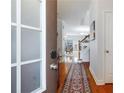 Inviting foyer with hardwood floors, a decorative rug, and a view into the open-concept living area at 108 Trailside Cir, Hiram, GA 30141