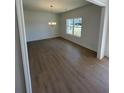 Open dining room features wood-look floors and a stylish chandelier at 1335 Tumblerock Way, Loganville, GA 30052