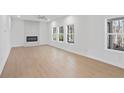 Bright living room featuring hardwood floors, fireplace, and multiple windows at 1335 Tumblerock Way, Loganville, GA 30052