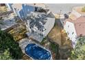 Aerial view of the home's backyard, showcasing a partially covered pool and well-maintained lawn at 6005 Pattingham Dr, Roswell, GA 30075